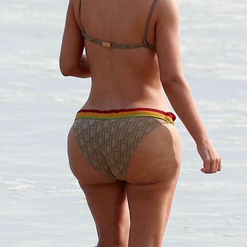 A woman walking on a beach, illustrating common areas for cellulite on the butt and thighs, for a guide by Body Sculpting Clinics Sydney on what treatments actually work.
