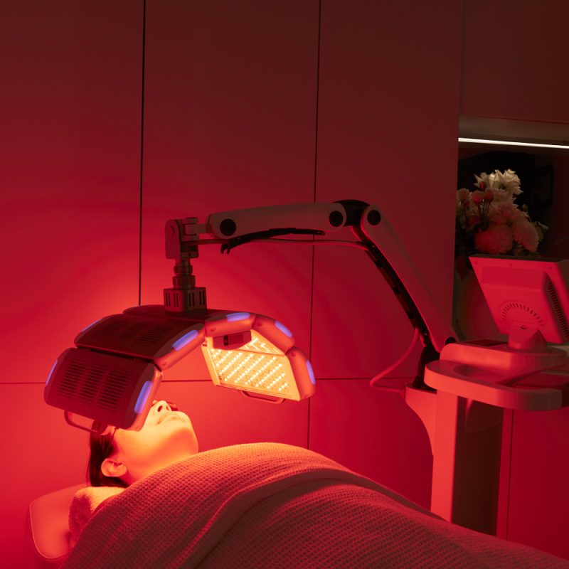 A client receiving a professional Red Light Therapy treatment at Body Sculpting Clinics Sydney, showing the LED light panels positioned for a 10-minute cellular rejuvenation session.